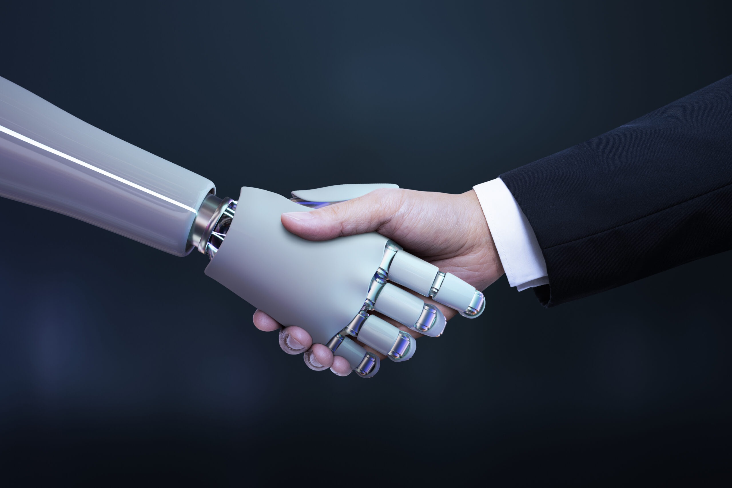 robot i człowiek ściskający dłonie